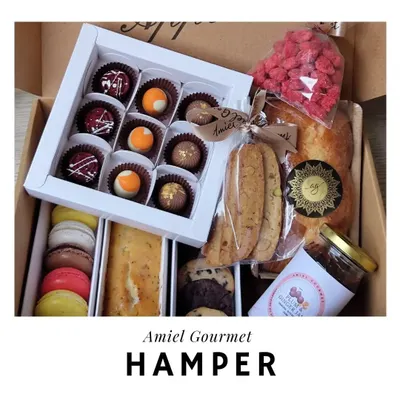 My gourmet hampers are filled with an assortment of my finest creations. This box includes chocolate bonbons, macarons, cookies, a tea cake, and more, making it a truly luxurious gift.