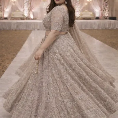 Feel beautiful and confident in this elegant plus-size lehenga in a subtle beige shade. The full skirt allows for a gorgeous twirl, showcasing the delicate all-over embroidery that shimmers as you move.
