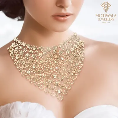 A breathtaking bridal collar necklace, crafted from a delicate web of gold and diamonds. This piece is designed to sit gracefully on the collarbone, creating a statement of pure opulence and sophistication.
