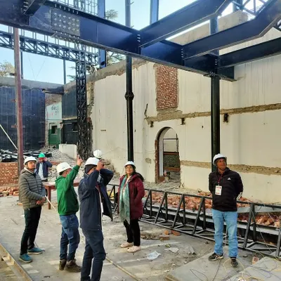 A site visit during the retrofit of Parker Hall at Woodstock School. This image shows our team collaborating with structural engineers to overcome technical challenges and integrate a new steel structure within the heritage building.