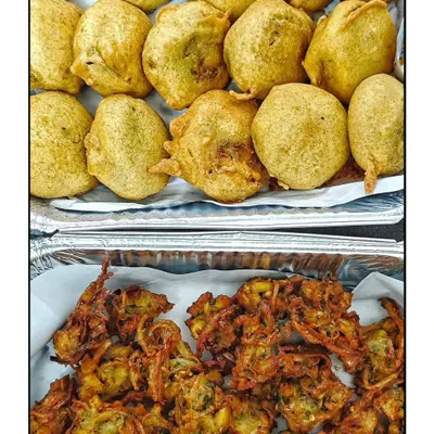 A classic combination for a rainy day or any evening. Freshly fried, hot Batata Vadas and crispy Onion Bhajiyas, also known as Khekda Bhaji, served as an evening snack.