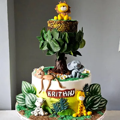 This showstopper jungle cake features a real rotating tier. The top tier, with the lion, actually spins, creating a dynamic and exciting centerpiece. All animals and the tree are handcrafted and edible.