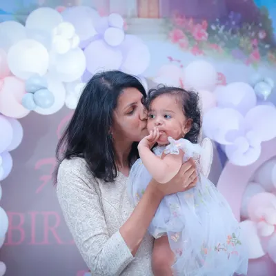 A mother's tender kiss is a memory to hold onto forever. We specialize in capturing these quiet, loving moments between a mother and her child during family celebrations.