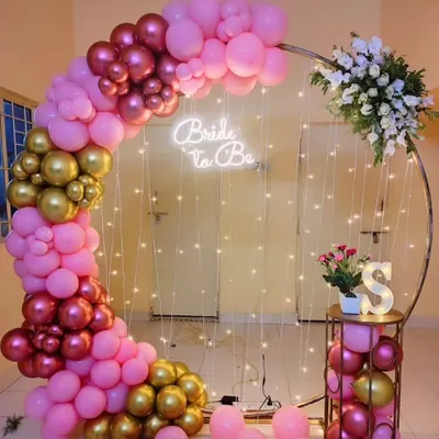 A beautiful 'Bride to Be' setup perfect for a bachelorette party or bridal shower. I used a circular frame with a pink and gold balloon arch, fairy lights, and a neon sign to create this elegant photo corner.