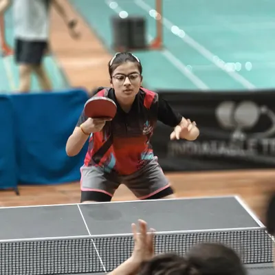 Focus in its purest form. A player executes a forehand shot during an intense rally at our academy. Every practice session is an opportunity to refine technique and build match-winning consistency.