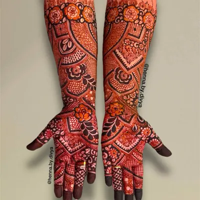 A stunning full-coverage bridal design that extends to the elbows. This piece is packed with intricate floral work, paisleys, and delicate checkered patterns for a truly grand look.