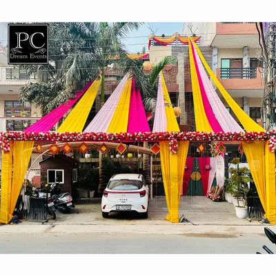 Creating that perfect 'shadi vala ghar' look. I used a canopy of bright pink and yellow drapes to create a grand tented entrance right outside the house for the wedding festivities.