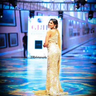 Capturing a model's confident look over the shoulder as she walks the runway. This shot freezes a perfect moment of interaction and attitude.