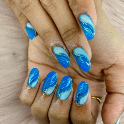 Inspired by ocean waves, this mesmerizing design features swirling patterns of light and dark blue with a hint of silver glitter, creating a beautiful sense of movement.