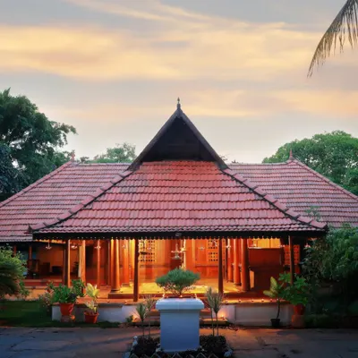 The historic Aranmula Palace, our reception building, stands as a testament to timeless Kerala architecture. This view captures its grandeur at sunset, inviting you into a world of royal heritage and healing.