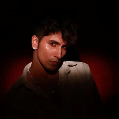 A powerful, moody portrait using dramatic side lighting to create deep shadows. This technique is great for sculpting features and creating an intense, cinematic look.