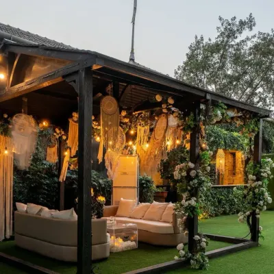 A cozy and stylish outdoor lounge I designed at Gallops Mumbai. This bohemian-inspired cabana features comfortable sofas, macrame dreamcatchers, and climbing white roses, creating the perfect spot for guests to relax.