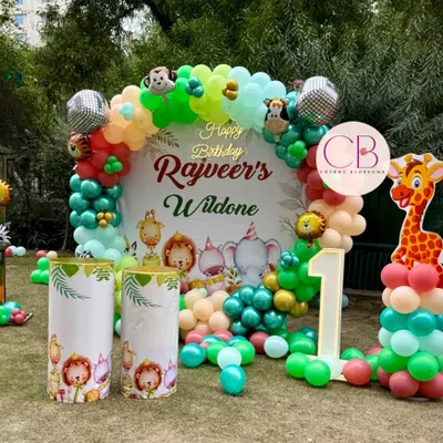 We transformed this outdoor lawn into a vibrant jungle for Rajveer's 'Wild One' first birthday party. This setup features a custom backdrop with a balloon arch, themed plinths, and character cutouts to create an immersive experience for the little guests.