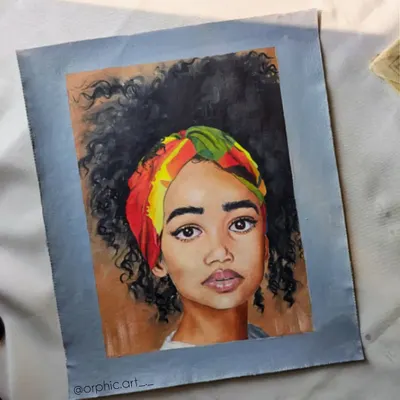 This is a finished oil portrait of a woman with a colorful headwrap and beautiful curly hair. I enjoyed working on the different textures in this piece, from her skin to her hair and the fabric of the wrap.
