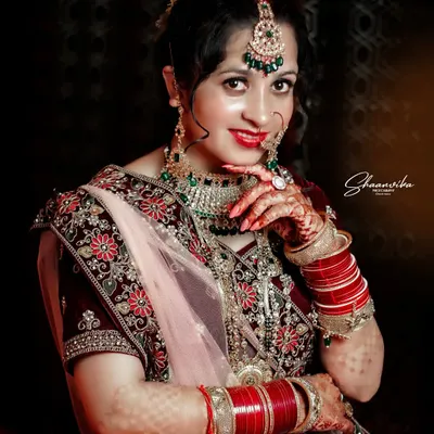 A gorgeous bride showing off her intricate henna and jewelry. This bridal portrait focuses on the important details that make up the complete wedding look.