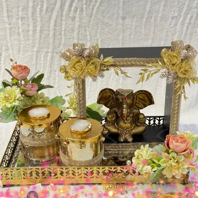 A divine Diwali hamper featuring a beautiful Ganesha idol. This arrangement includes agate-lidded jars and is set on a mirrored gold tray, making it a perfect centerpiece for your festive decor.