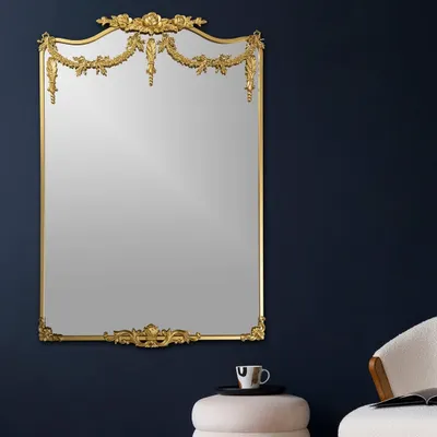This mirror is a masterpiece of classic design. The ornate, gilded frame with delicate garlands and flourishes makes it more than just a mirror; it's a piece of art that adds a touch of royal elegance to any room.