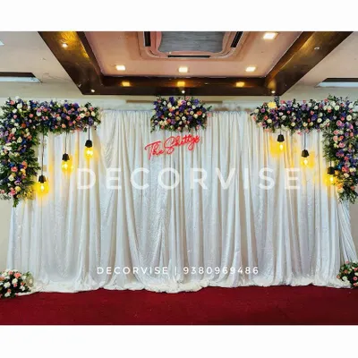 A custom neon sign is a great way to personalize your event. For this engagement, I created a sign with the family's surname, "The Shettys," which served as a central feature of the sparkling sequin backdrop.