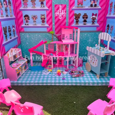 A complete imaginative play corner set up for an LOL Surprise and Barbie themed party. This setup includes the Barbie Dream House, a pretend play kitchen, an ice cream cart, and kid-sized seating.