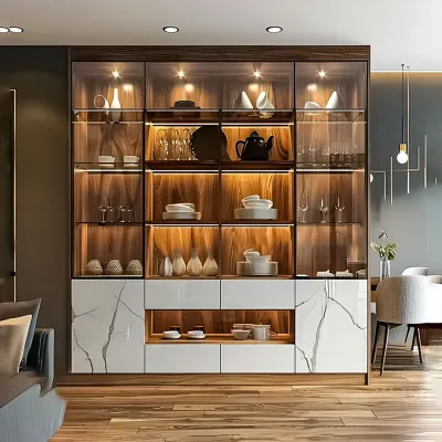 Our modern crockery cabinets are designed to display your finest dinnerware. This unit features a blend of wood, glass doors, and a marble-finish base, with internal backlighting to highlight your collection. It provides both open display shelves and concealed drawers for versatile storage.