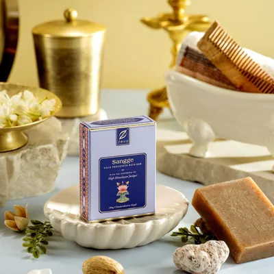 An elaborate setup for Zeva's 'Sangee' bath soap, featuring traditional bathing elements like a miniature tub, comb, and fresh jasmine. This composition evokes a sense of luxurious, time-honored self-care rituals.