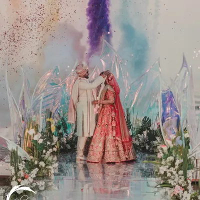 A truly unique Jaimala moment. I arranged for colored smoke to be released as the couple exchanged garlands, creating a vibrant, artistic, and unforgettable memory against the backdrop of the modern beach mandap.