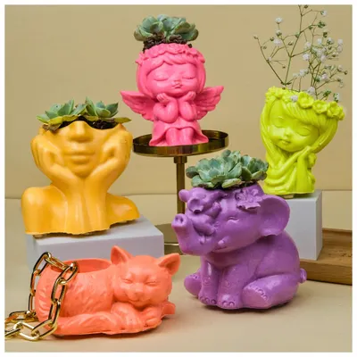 A colorful collection of my figurine-shaped Jesmonite planters. From sleepy cats to serene angels and elephants, these small pots are perfect for succulents and add a playful touch to your space.