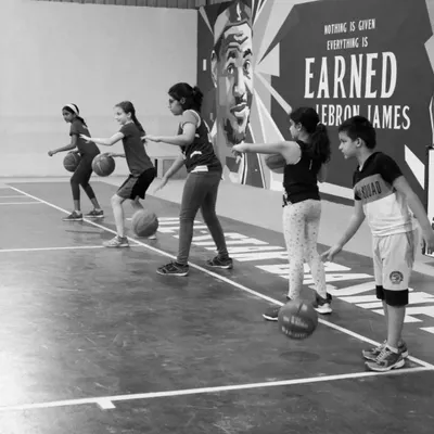 Our U10 and lil-hoops players lined up and focused. We start with the basics of ball handling, teaching them control and coordination in a fun, structured way.