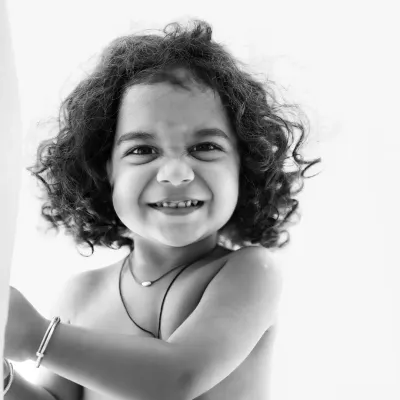 A mischievous and joyful grin captured in a stunning black and white close-up. This image is all about pure personality.