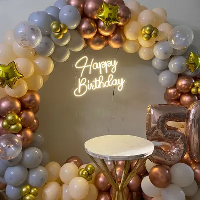 I design elegant backdrops for milestone birthdays, like this 50th celebration setup. This features a full circular balloon arch in a sophisticated rose gold, white, and grey palette, a custom neon 'Happy Birthday' sign, and large foil balloons for the age.