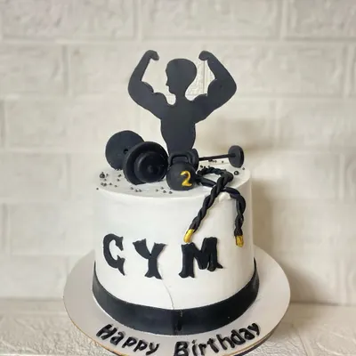 Strong mind, stronger body. A blueberry cake for the gym freak in your life, complete with fondant dumbbells, kettlebells, and a bodybuilder silhouette.