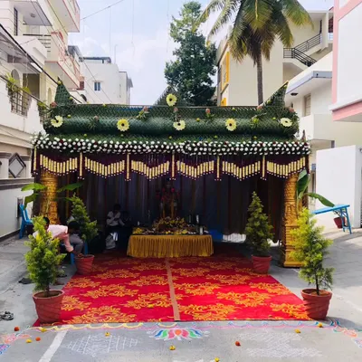 A video showing the construction and final look of a traditional chapra for a housewarming. The structure is made from palm leaves and decorated with marigold flowers and other auspicious items.