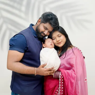 A beautiful portrait of a new family of three. I focus on capturing the love and connection as parents hold their newborn baby for the first time.