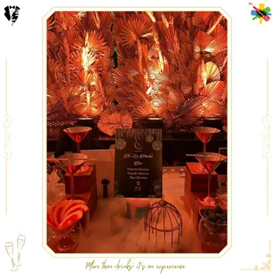 A dramatic Martini Bar setup featuring dry ice for a smoky, theatrical effect. The golden palm backdrop and tiered display create a sense of opulence and sophistication.