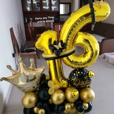 A striking 16th birthday balloon bouquet in black and gold. It features large foil numbers, a crown balloon, and intricate balloon twisting details.