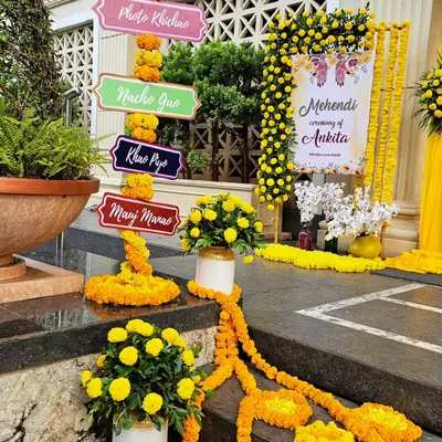 A classic Haldi and Mehendi entrance, bursting with the vibrant yellow of marigold flowers. We created fun, quirky signages like 'Photo Khichao' and 'Nacho Gao' to set a playful and celebratory mood right from the start.