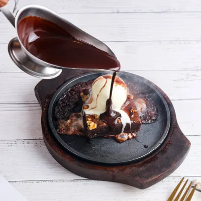 The sizzle, the steam, the pour. Capturing this sizzling brownie in action is all about making the viewer feel the heat and anticipate the first bite.
