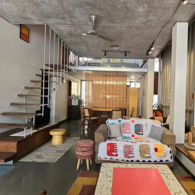 My home and studio is an open-plan loft space, where living and working areas flow into one another. The design uses a simple palette of exposed concrete, steel, and Kota stone, with a floating staircase that keeps the space feeling light and connected.