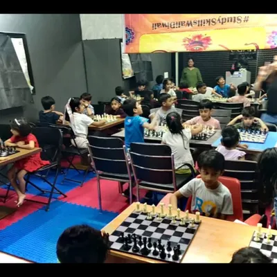 A wide view of our chess class in full swing during the summer camp. The room is buzzing with quiet concentration as students engage in matches and learn new strategies.