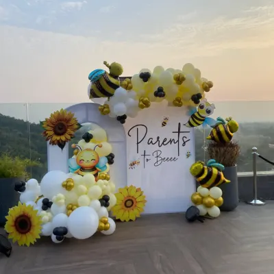 A sweet celebration for the "Parents to Bee." We designed this adorable bee-themed baby shower at a stunning rooftop location in Dehradun, complete with a custom backdrop, sunflower accents, and a yellow, white, and black balloon arrangement.