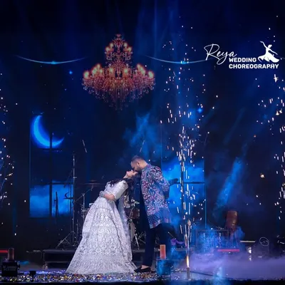 Dancing under the moonlight, lost in their own world. This shot captures the pure romance of a couple's performance. The dip, the pyrotechnics, the chemistry, it's a perfect filmy moment.