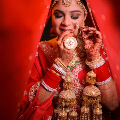 A classic bridal portrait. Here, I focused on creating a flawless base that lasts through all the ceremonies, paired with traditional red and gold tones on the eyes and lips. The final look is timeless, highlighting her beautiful features and ornate jewelry.