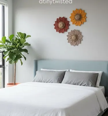 Imagine these handmade macramé flowers bringing a bit of sunshine into your home. I designed this set of three in warm, earthy tones to add a touch of modern boho charm above a bed, but they look just as lovely in a living room or entryway.