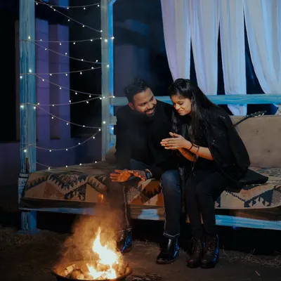 A cozy and romantic night shoot setup with a bonfire. This is a perfect example of how we can create a warm and intimate atmosphere in a studio setting.