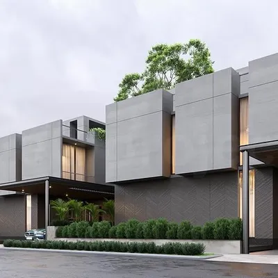 A street view of prototypes for a housing master plan in Bangalore. The design uses a consistent palette of concrete and dark tones to create a cohesive neighborhood identity, with individual homes distinguished by subtle variations in form.