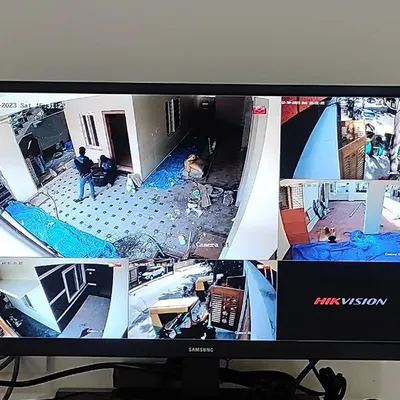 A live multi-view display from a Hikvision IP camera installation. You can see different angles of a property, including the entrance, hallways, and kitchen, all on one screen.
