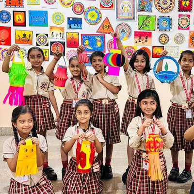 Our art sessions often incorporate cultural themes, such as this Diwali lantern-making workshop. Students proudly display their colorful creations, learning about festive traditions while honing their crafting skills.