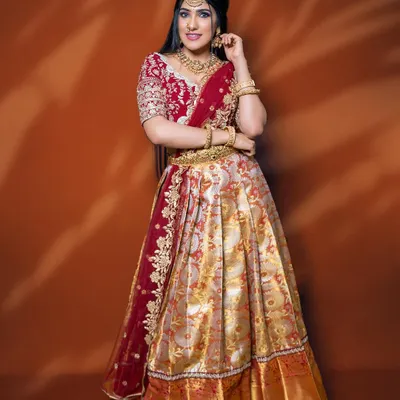 This is a classic Langa Voni from my collection, featuring a red and gold brocade skirt and a beautifully embroidered maroon blouse. It’s a perfect outfit for an engagement ceremony.