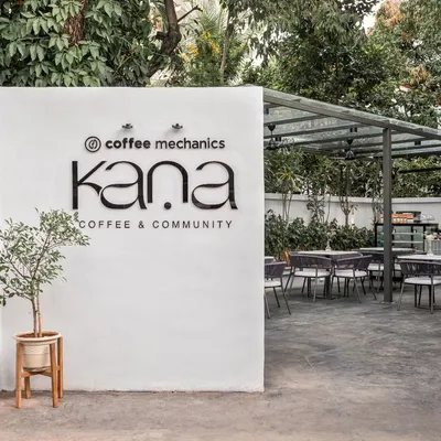 The entrance to Kana Cafe in Bangalore, a project conceived as an urban retreat. The design was inspired by breaking down barriers between the interior and exterior, allowing the serene, natural setting to become an integral part of the cafe experience.