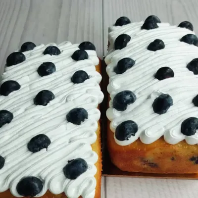 My Blueberry Tea Cake is a simple classic. The loaf is infused with fresh blueberries and topped with a light, airy whipped cream and more fresh berries.